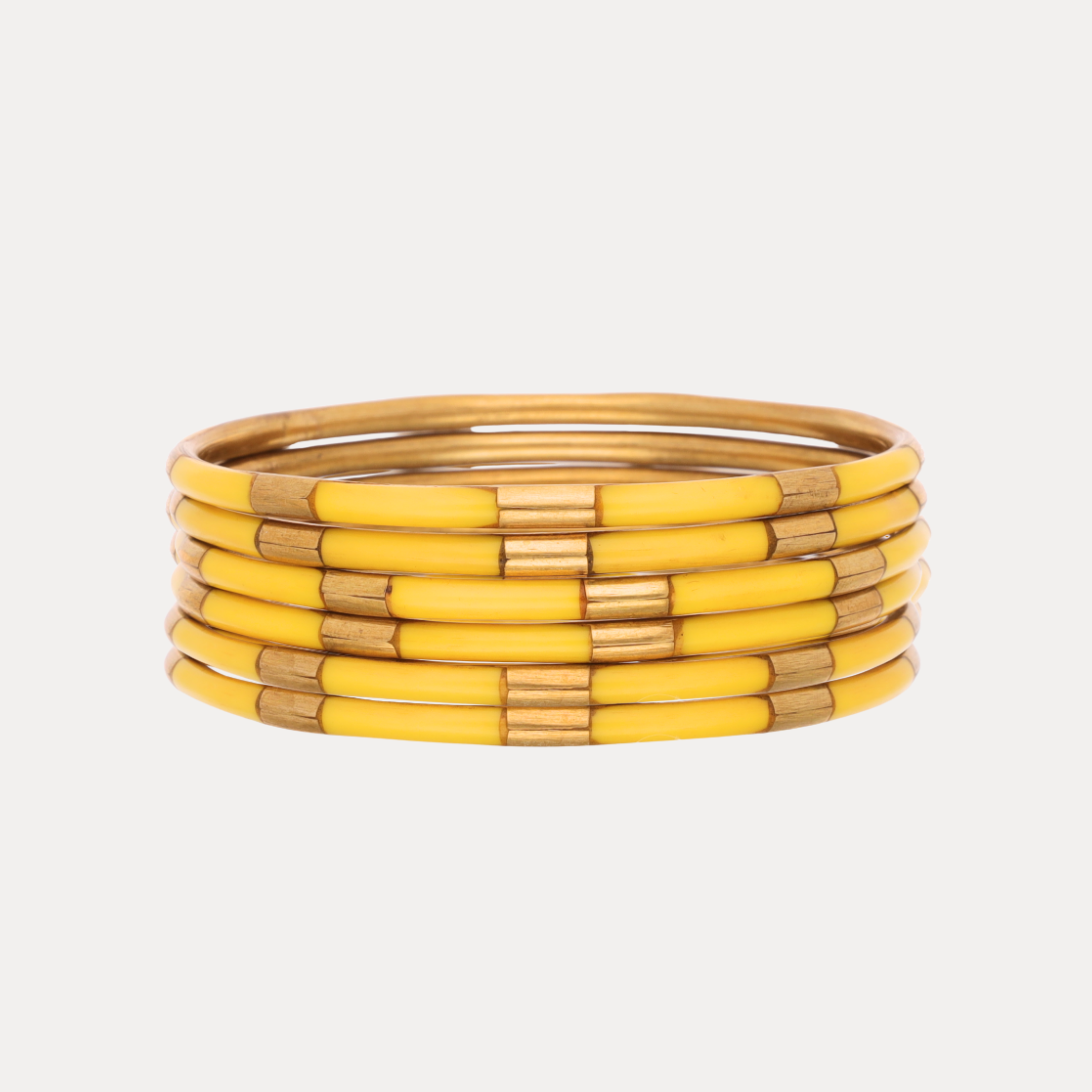 a stack of yellow bracelets